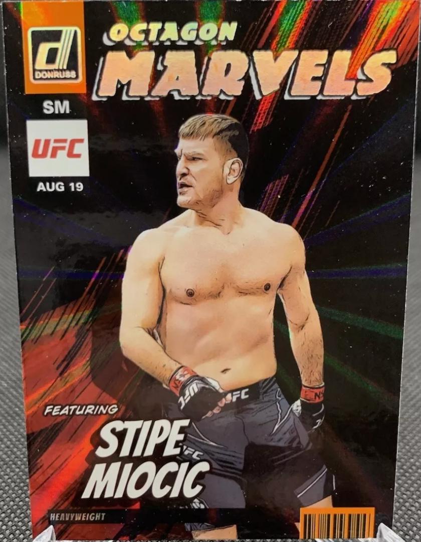Stipe Miocic 2023 Panini Donruss UFC Octagon Marvels #9 Orange Laser
