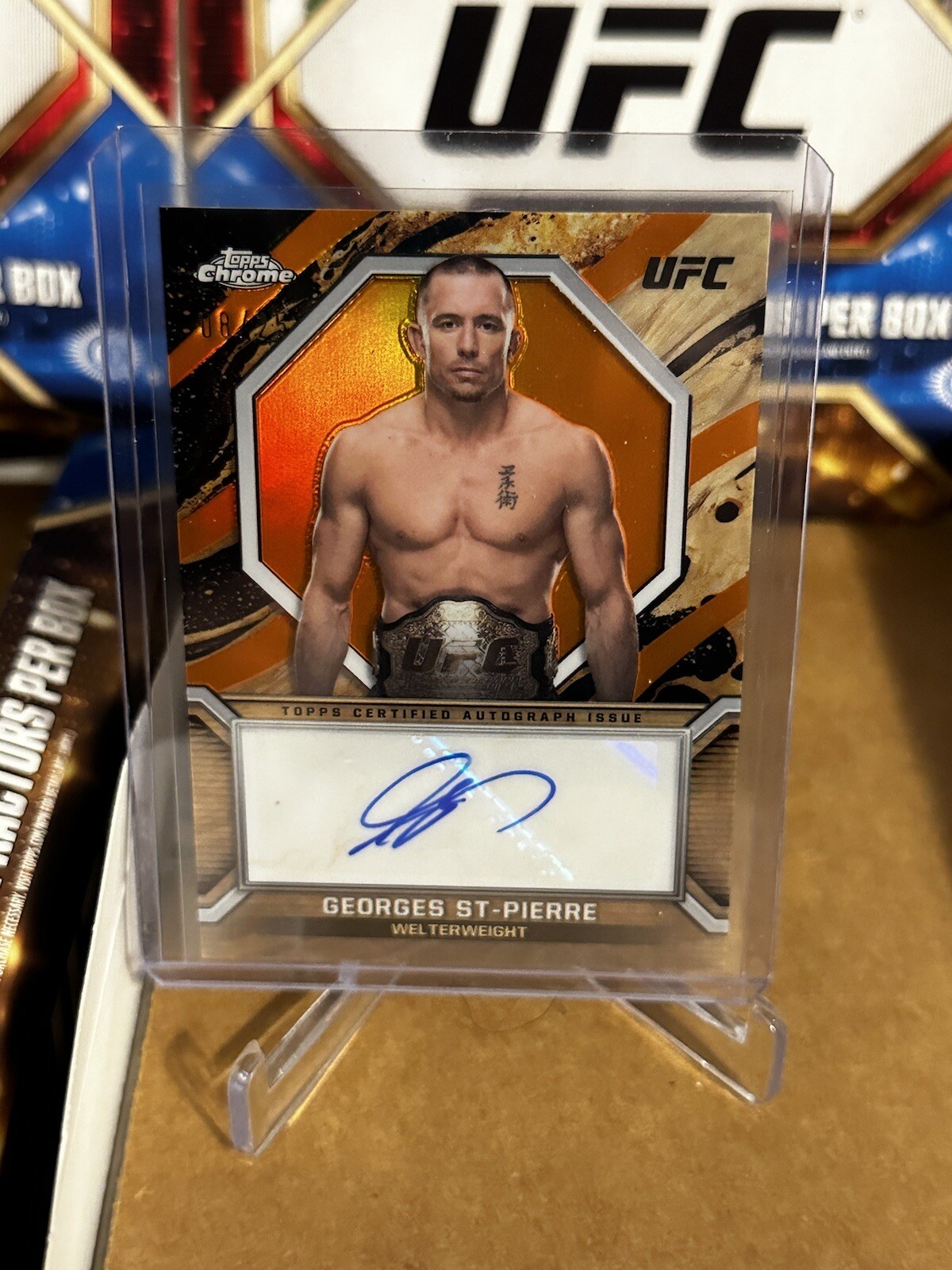Georges St-Pierre 2024 Topps Chrome UFC Marks of Champions #MOC-GSP Orange Refractor
